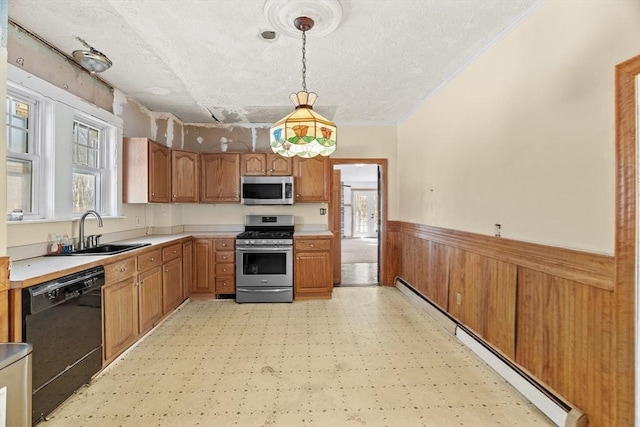 1210 Highland St, Holliston, MA 01746 - kitchen with appliances with stainless steel finishes, wainscoting, baseboard heating, light flooring, and a textured ceiling