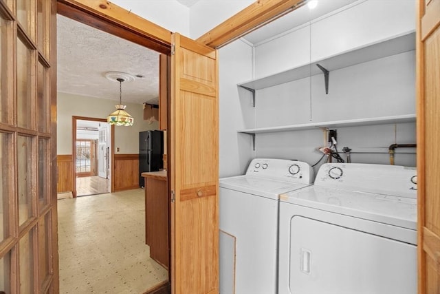1210 Highland St, Holliston, MA 01746 - laundry area with washer and dryer, a wainscoted wall, and light flooring