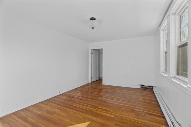 1210 Highland St, Holliston, MA 01746 - unfurnished room featuring a baseboard heating unit and wood finished floors