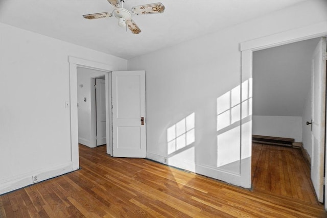 1210 Highland St, Holliston, MA 01746 - empty room with wood finished floors, a ceiling fan, and a baseboard heating unit
