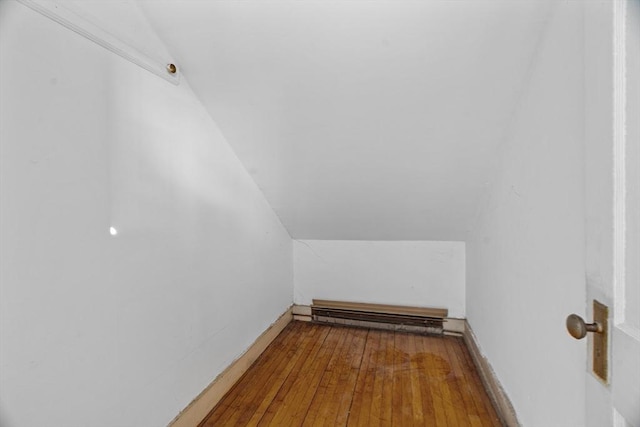 1210 Highland St, Holliston, MA 01746 - bonus room with a baseboard radiator, lofted ceiling, and hardwood / wood-style flooring