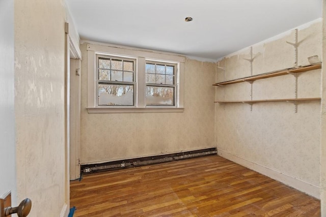 1210 Highland St, Holliston, MA 01746 - unfurnished room with wood finished floors and a baseboard heating unit