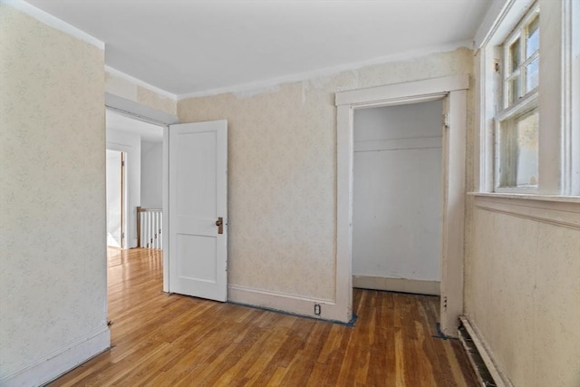 1210 Highland St, Holliston, MA 01746 - unfurnished bedroom featuring wood finished floors, wallpapered walls, and a closet