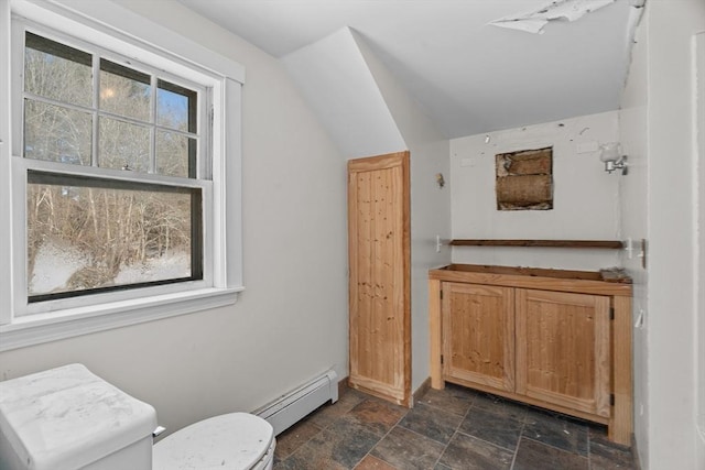 1210 Highland St, Holliston, MA 01746 - bathroom featuring a baseboard heating unit, stone finish flooring, and lofted ceiling
