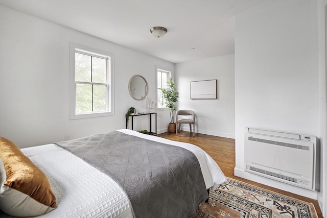 9 Cedar St Unit 1, Boston, MA 02119 - bedroom with wood finished floors, heating unit, and baseboards