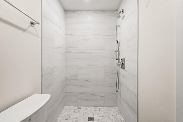 bathroom with a tile shower