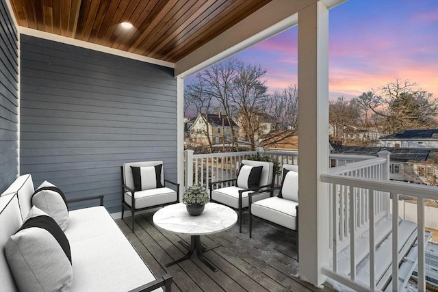 deck at dusk with an outdoor hangout area