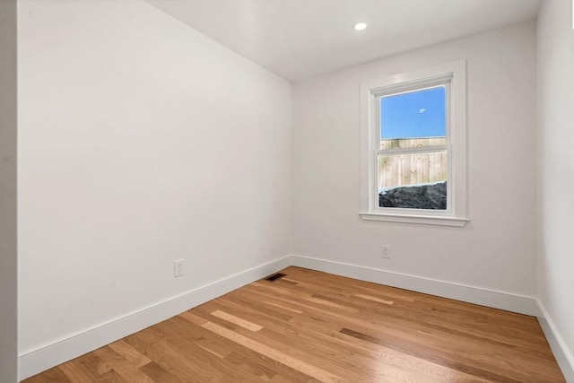 unfurnished room with light wood-type flooring