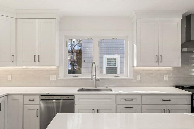 kitchen with wall chimney exhaust hood, sink, white cabinetry, range, and stainless steel dishwasher