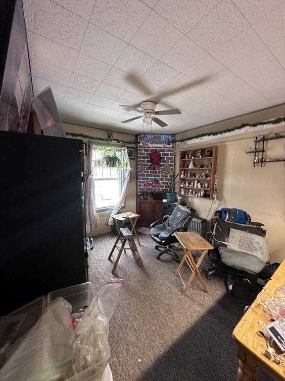 interior space with ceiling fan and carpet floors