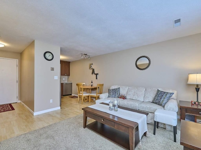 71 Princeton St Unit 305, Chelmsford, MA 01863 - living area with baseboards, light wood-style floors, and light colored carpet