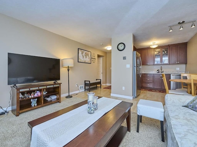 71 Princeton St Unit 305, Chelmsford, MA 01863 - living room featuring wet bar, baseboards, and light colored carpet