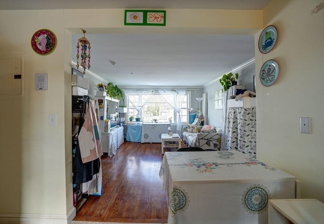 kitchen with crown molding and dark wood-type flooring