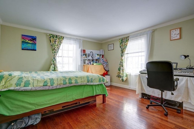 bedroom featuring multiple windows, hardwood / wood-style flooring, and crown molding