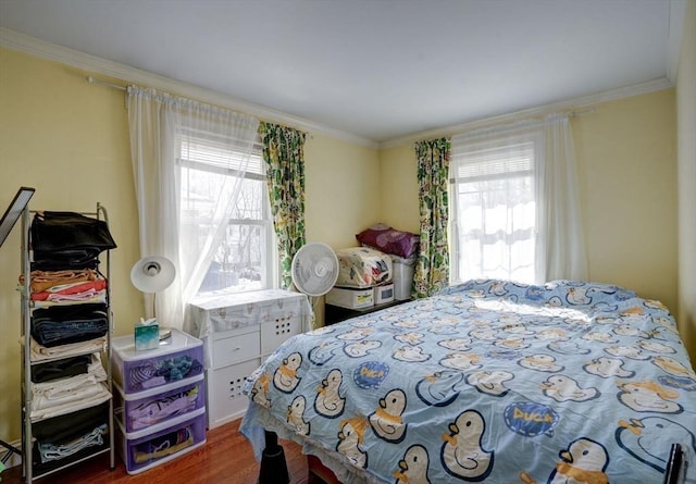 bedroom featuring ornamental molding and dark hardwood / wood-style flooring