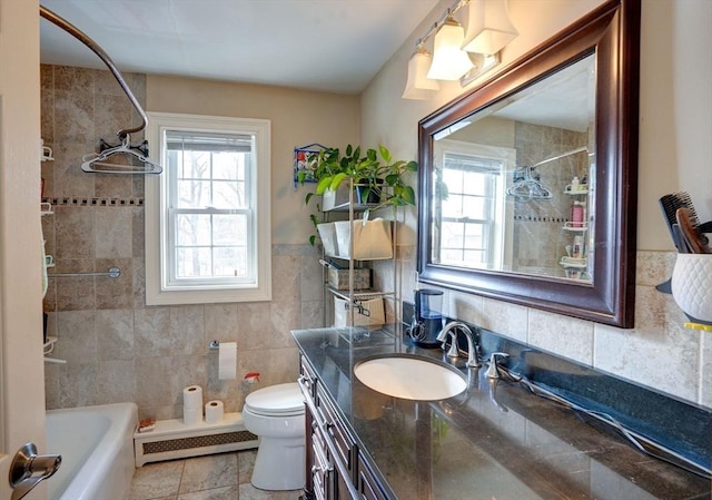 bathroom with toilet, tile walls, baseboard heating, tile patterned floors, and vanity