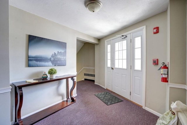 carpeted foyer entrance with radiator