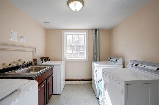 washroom with sink, cabinets, and independent washer and dryer