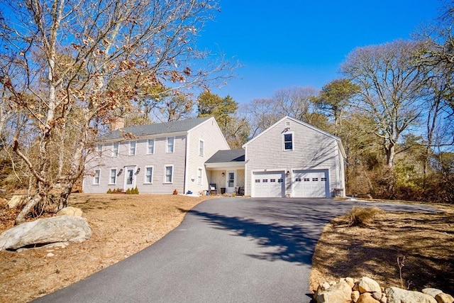 colonial-style house with aphalt driveway