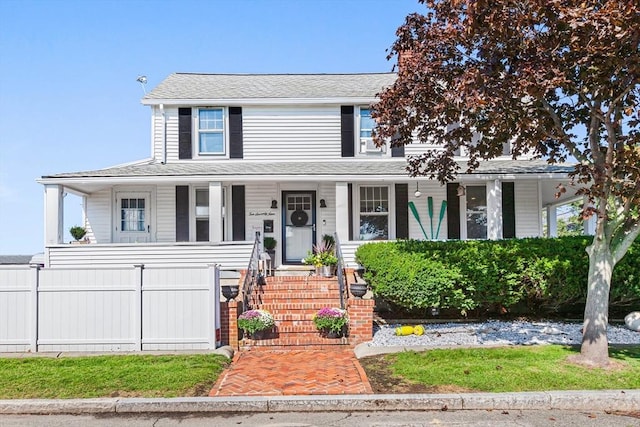 view of front of house with covered porch and fence