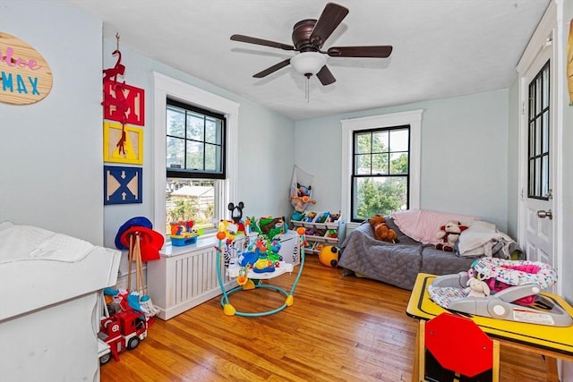 recreation room with ceiling fan and wood finished floors