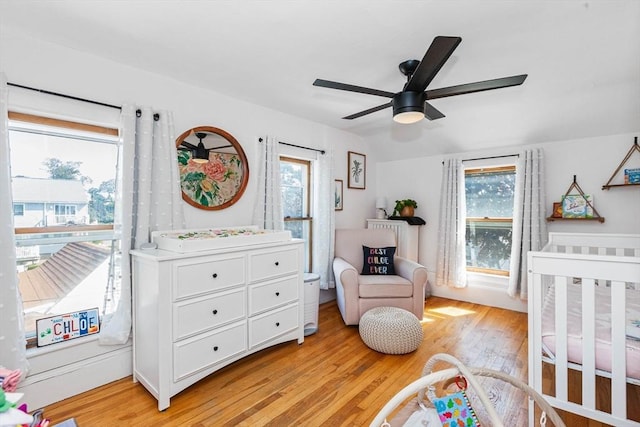 bedroom with light wood-style floors, lofted ceiling, and ceiling fan