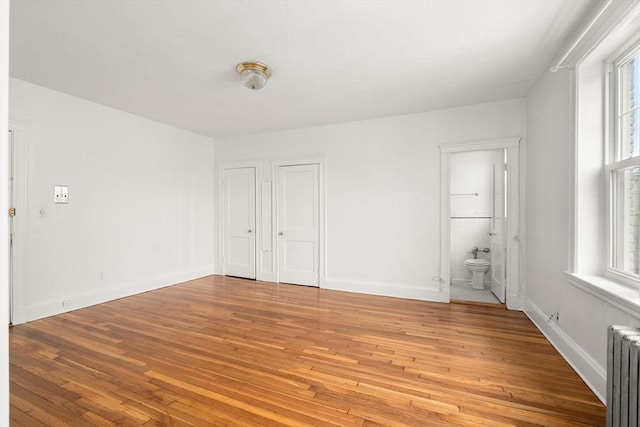 97 Chester St Unit 8, Boston, MA 02134 - spare room featuring radiator, light wood-type flooring, and healthy amount of natural light