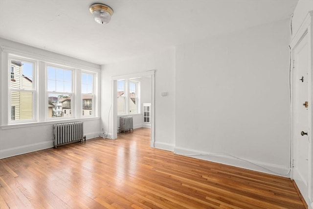 97 Chester St Unit 8, Boston, MA 02134 - spare room featuring radiator heating unit and light wood finished floors