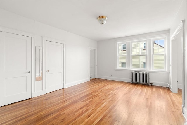 97 Chester St Unit 8, Boston, MA 02134 - unfurnished bedroom with radiator heating unit and light wood finished floors