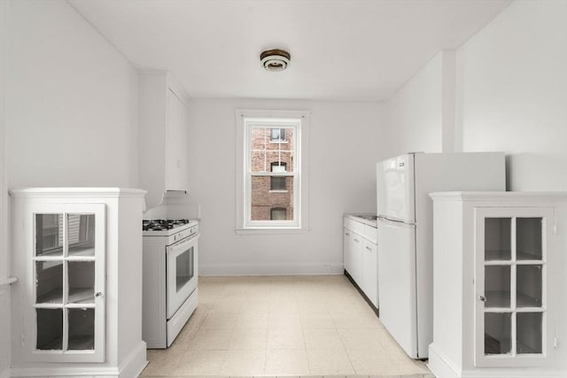97 Chester St Unit 8, Boston, MA 02134 - kitchen with white appliances, white cabinets, and light countertops