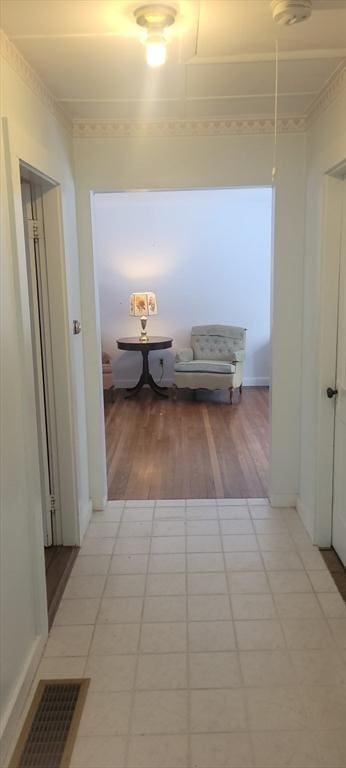 hall with light tile patterned floors