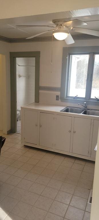 kitchen featuring sink, white cabinets, and ceiling fan