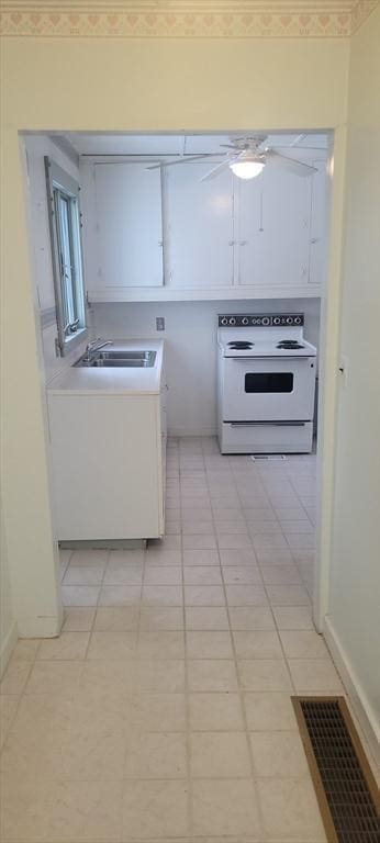 kitchen featuring white cabinetry, light tile patterned floors, sink, and electric range