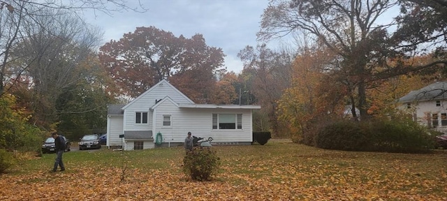 rear view of property with a yard