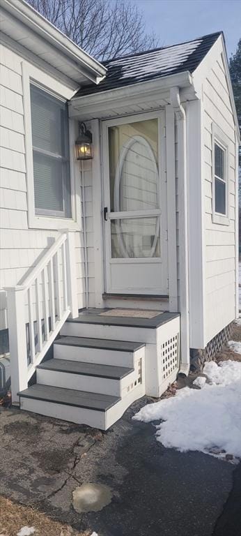 view of snow covered property entrance