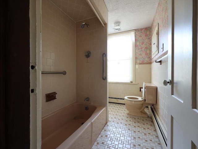 full bath featuring washtub / shower combination, wallpapered walls, a baseboard heating unit, and toilet