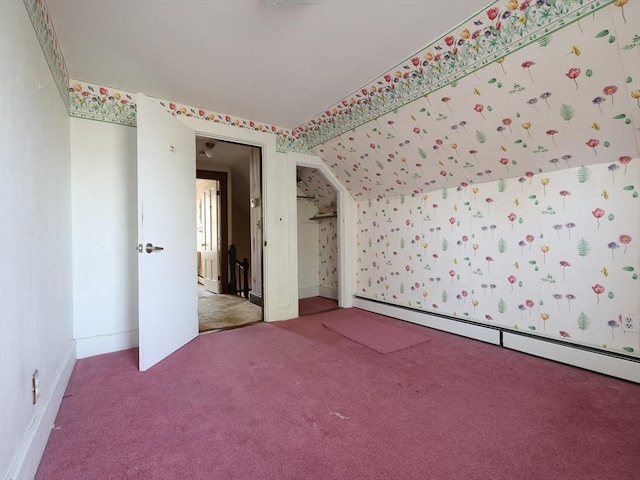 unfurnished bedroom featuring a closet, baseboards, baseboard heating, and carpet flooring