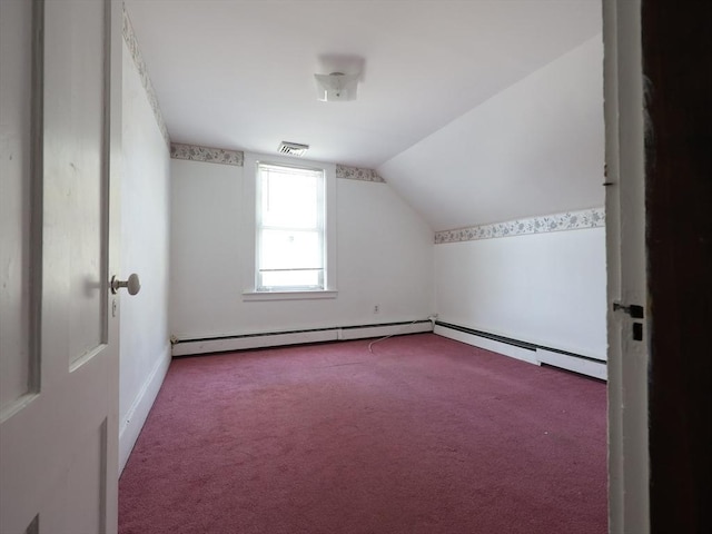 additional living space with visible vents, carpet flooring, baseboards, and vaulted ceiling