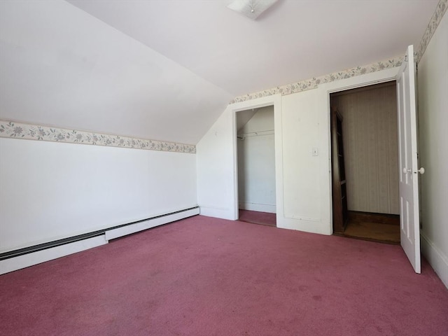 additional living space with carpet, lofted ceiling, and a baseboard heating unit