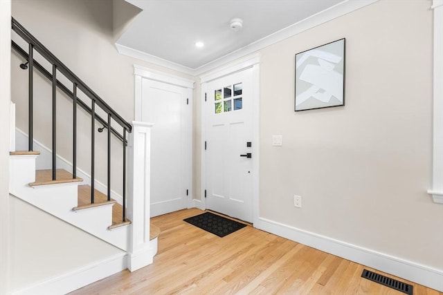 586 Lowell St, Peabody, MA 01960 - foyer with wood finished floors, stairway, and ornamental molding