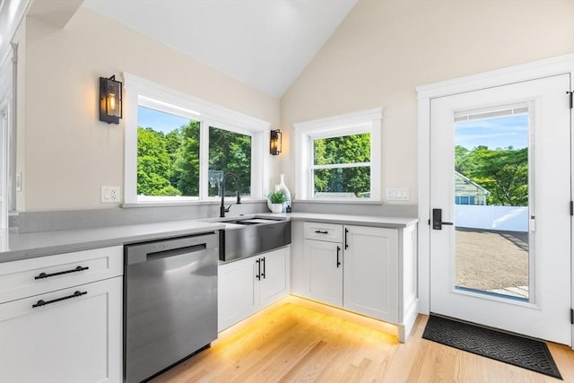 586 Lowell St, Peabody, MA 01960 - kitchen with dishwasher, light wood-type flooring, healthy amount of natural light, light countertops, and vaulted ceiling