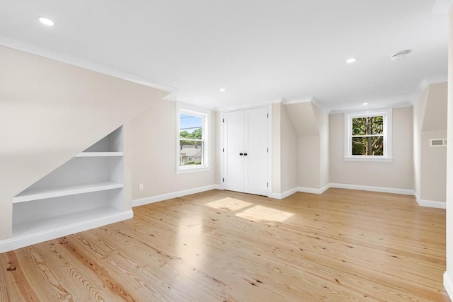 586 Lowell St, Peabody, MA 01960 - bonus room with built in shelves, light wood-style floors, and recessed lighting