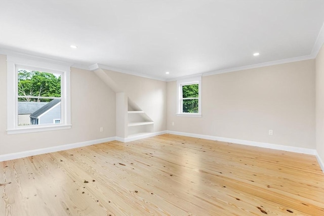 586 Lowell St, Peabody, MA 01960 - empty room with crown molding, built in shelves, light wood-style flooring, and recessed lighting