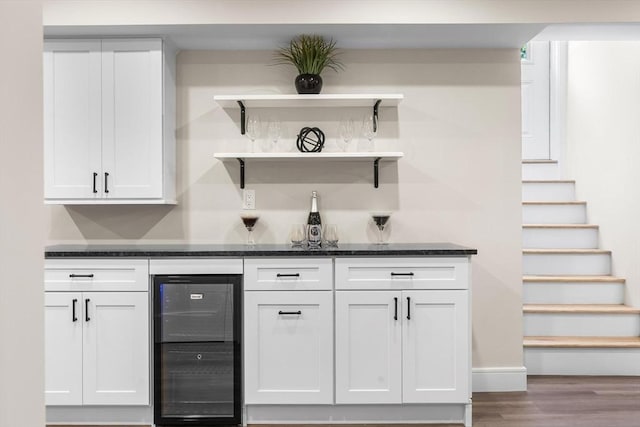 586 Lowell St, Peabody, MA 01960 - indoor dry bar featuring wine cooler, wood finished floors, and stairs