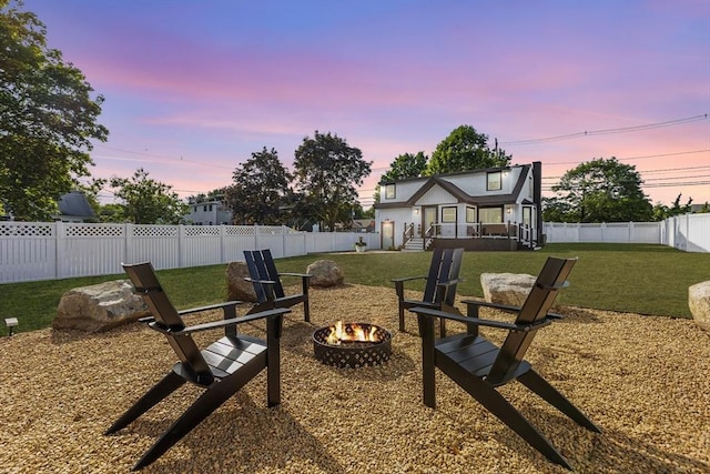 586 Lowell St, Peabody, MA 01960 - fenced backyard featuring a fire pit