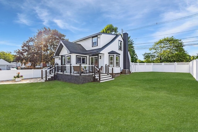 586 Lowell St, Peabody, MA 01960 - back of property with a fenced backyard and a chimney