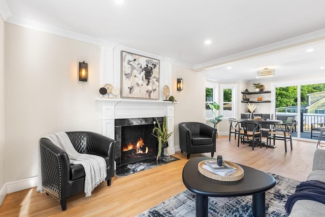 586 Lowell St, Peabody, MA 01960 - living area with a fireplace, wood finished floors, crown molding, and recessed lighting