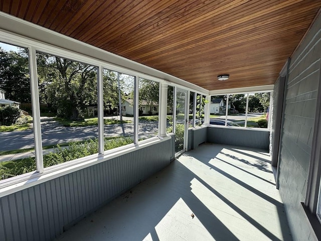 unfurnished sunroom with wooden ceiling