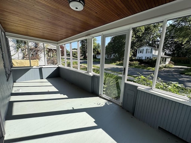 unfurnished sunroom featuring wood ceiling