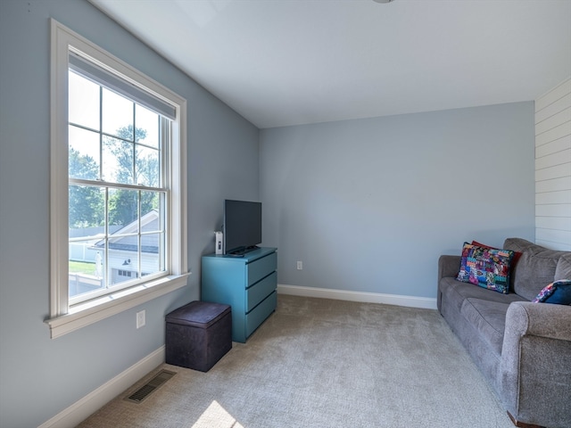 living room featuring a healthy amount of sunlight and light carpet